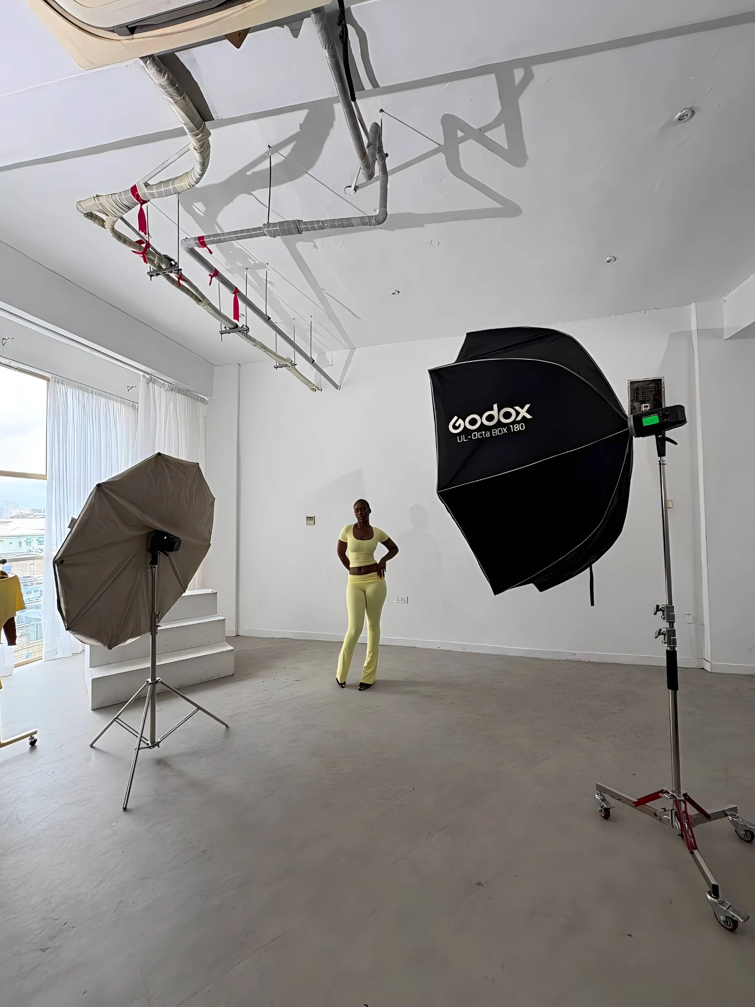 Behind the scenes at a Creative Pie shoot: a model on set between studio lights